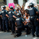 A man screams with emotion as he sees a policeman take a knee while hundreds protest the death of George Floyd next to the White House on May 31, 2020 in Washington, DC.